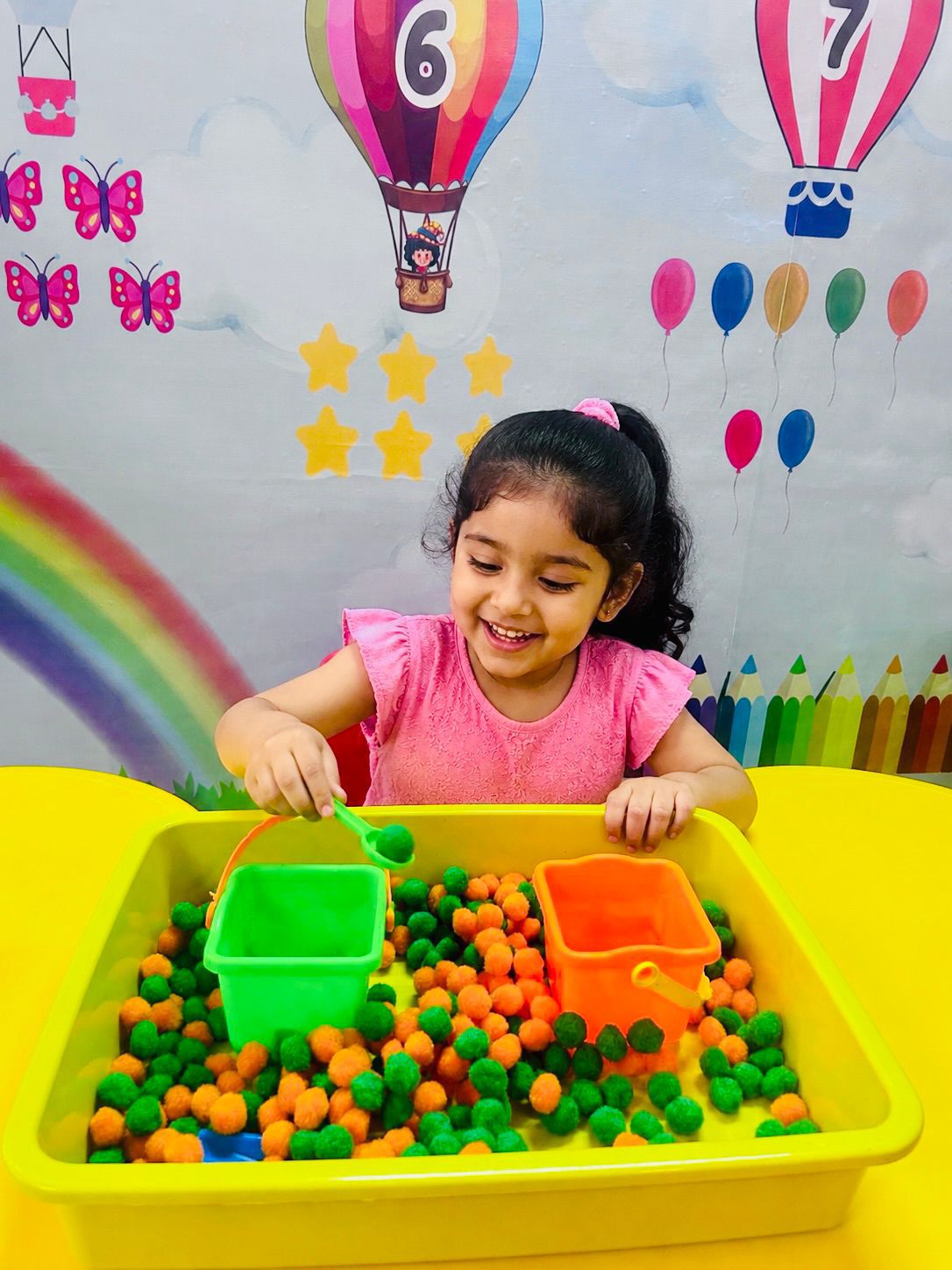 Child exploring hands-on sensory play materials